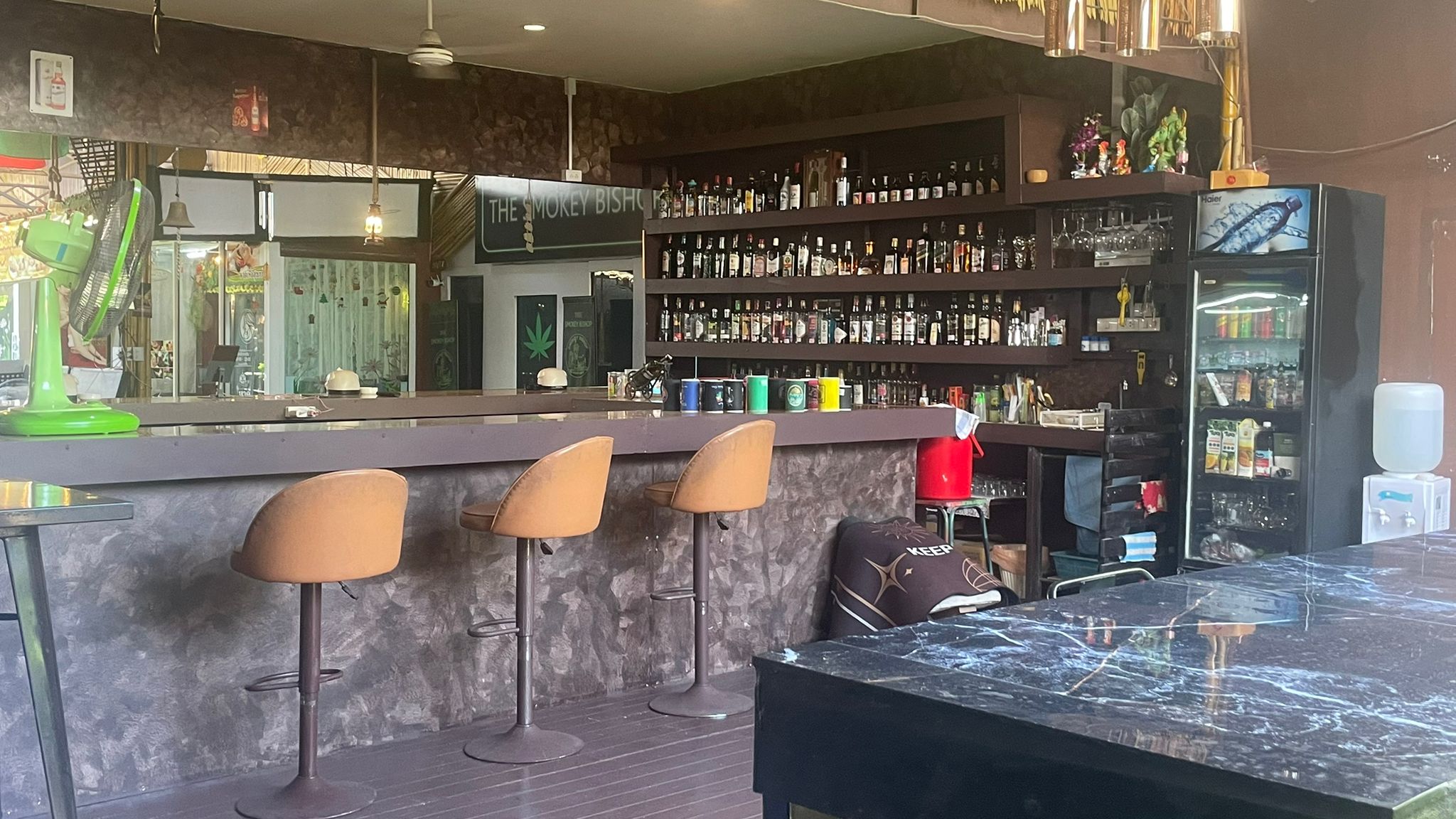 The well-stocked back bar with leather stools, spirits shelves and drinks fridge