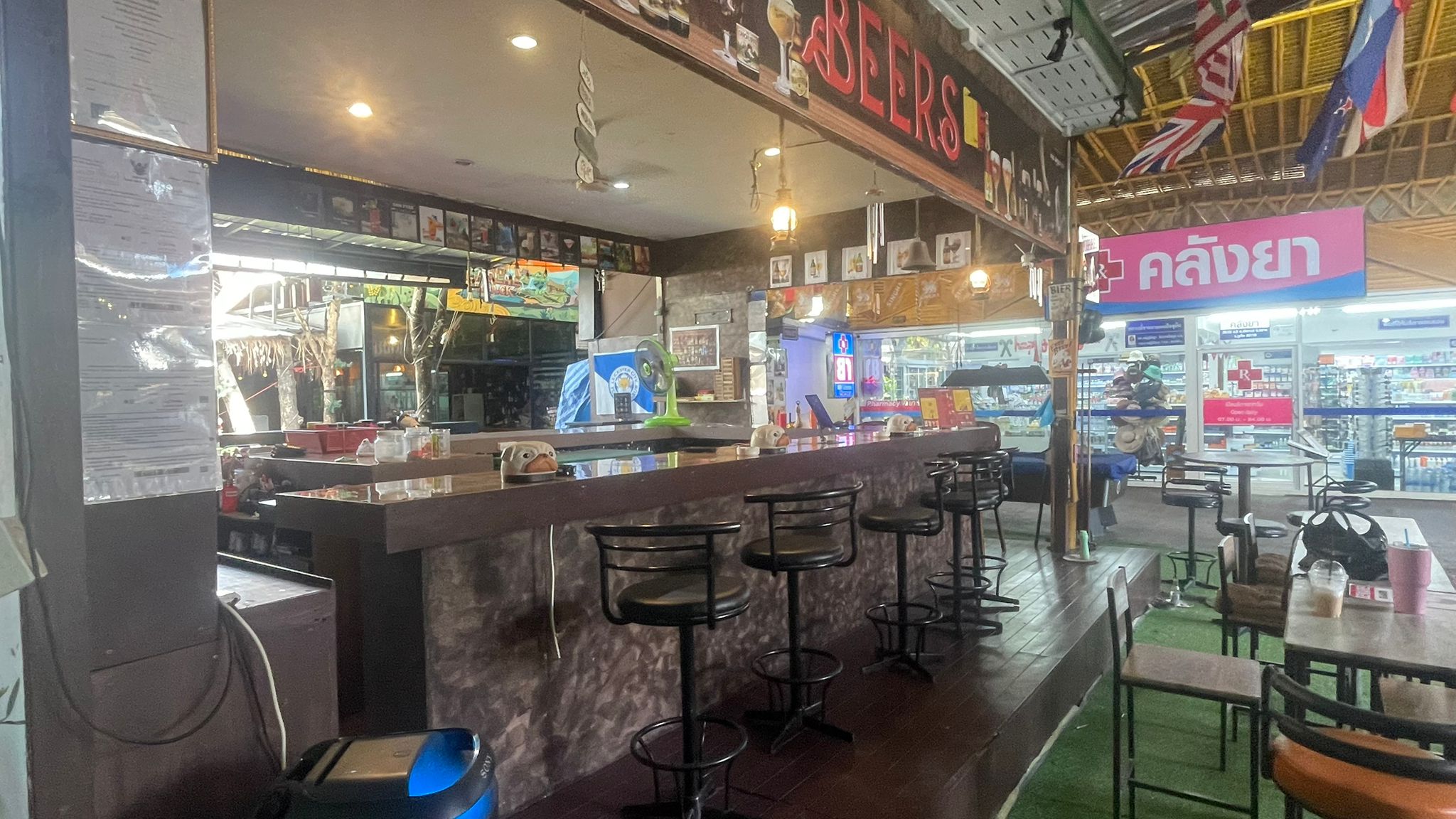The Squirrel Bar's main bar counter with stools and a red Beers neon sign