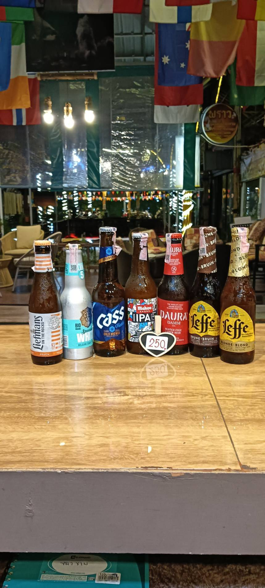 Liefmans, Bio Organic White, Cass, Mahou IPA, Daura Damm and Leffe bottles, priced at 250 baht