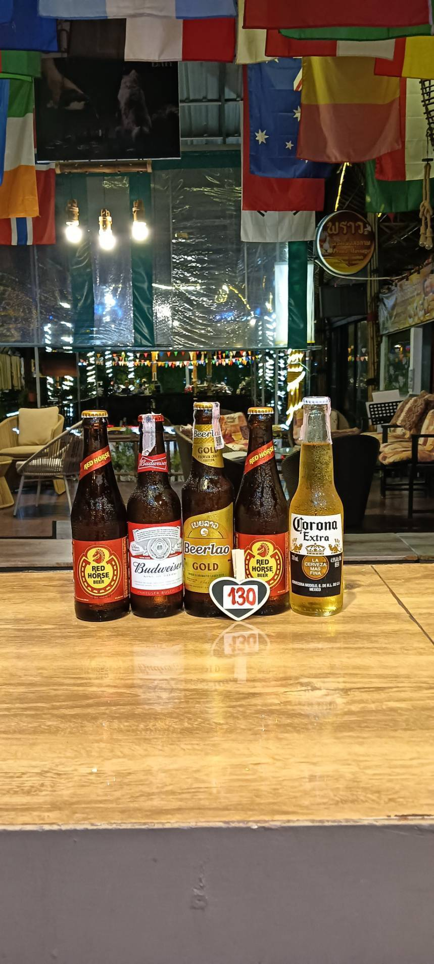 Red Horse, Budweiser, Beerlao Gold and Corona Extra bottles, priced at 130 baht