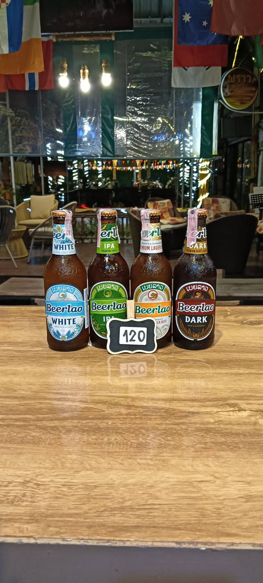 Beerlao White, IPA, Lager and Dark bottles, priced at 120 baht