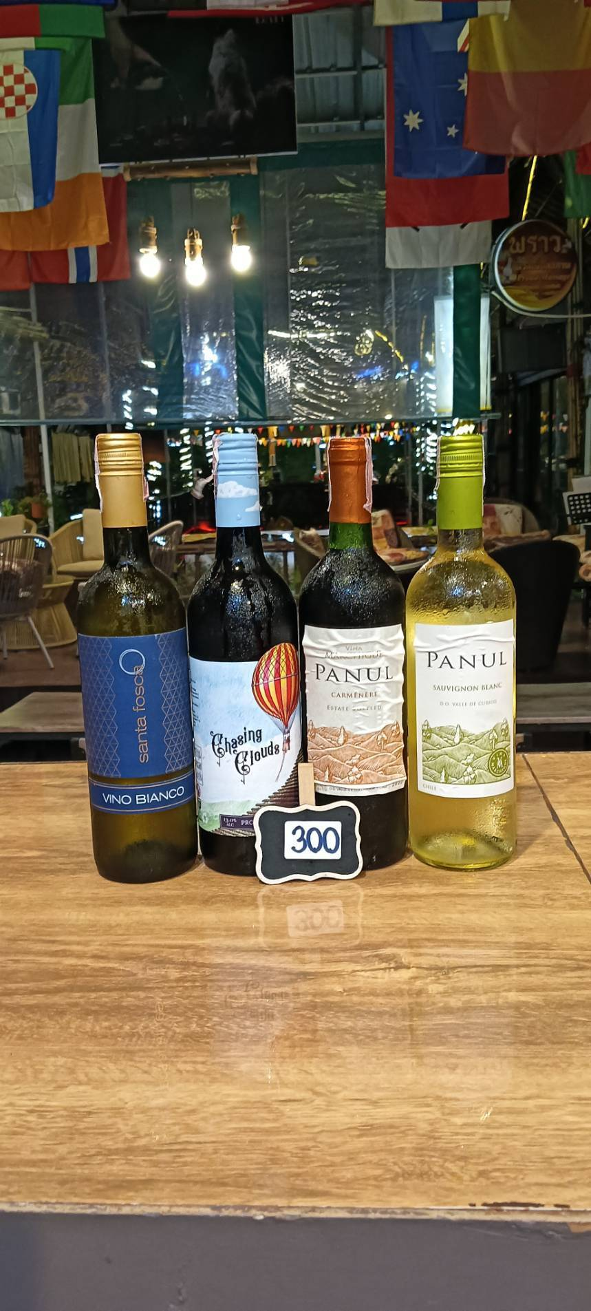 Santa Fosca Vino Bianco, Chasing Clouds Prosecco, Panul Carménère and Panul Sauvignon Blanc wine bottles, priced at 300 baht
