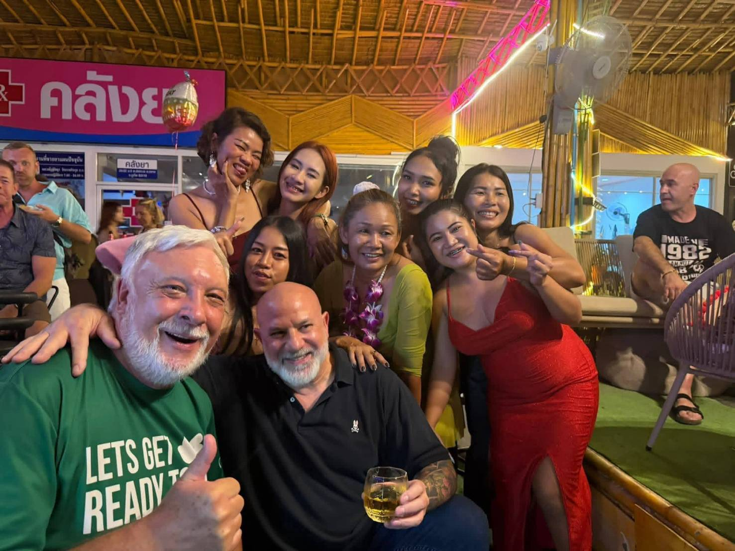 A happy international group of friends posing together for a selfie at The Squirrel Bar