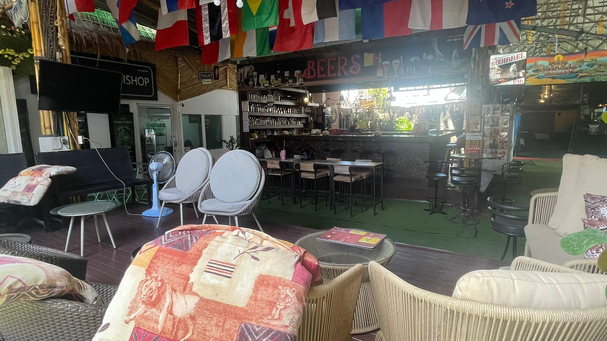 Comfortable cushioned seating area in front of the stocked bar